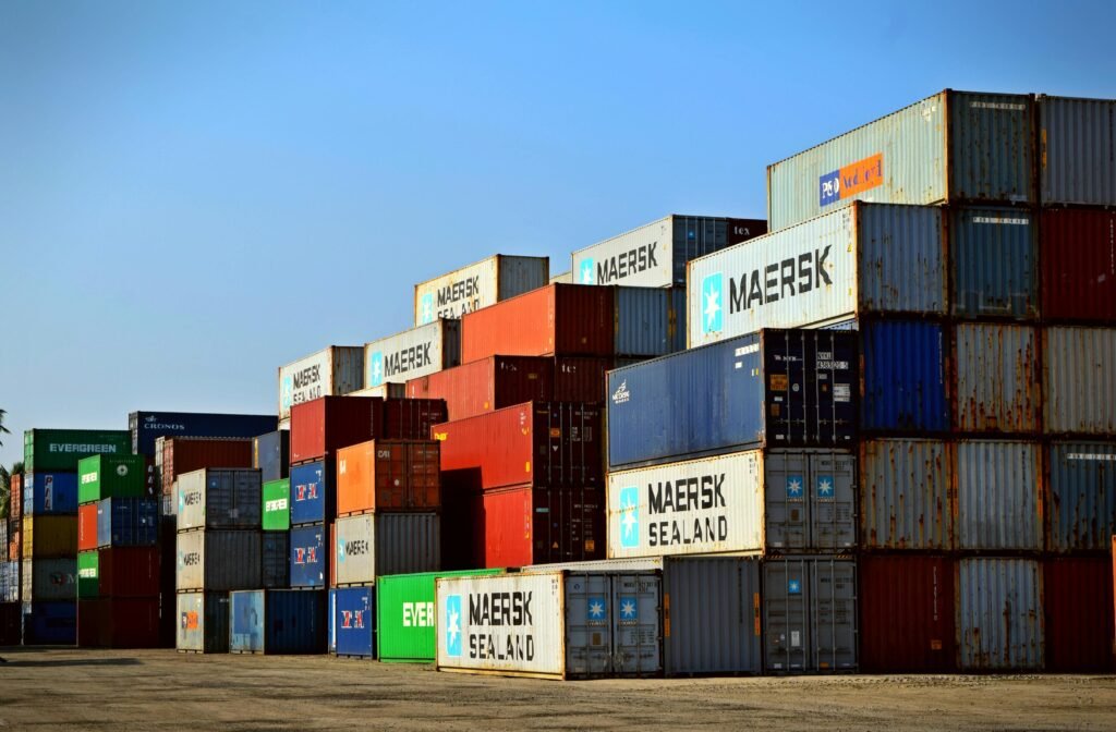 Colorful stacked shipping containers at a port exemplify global logistics.